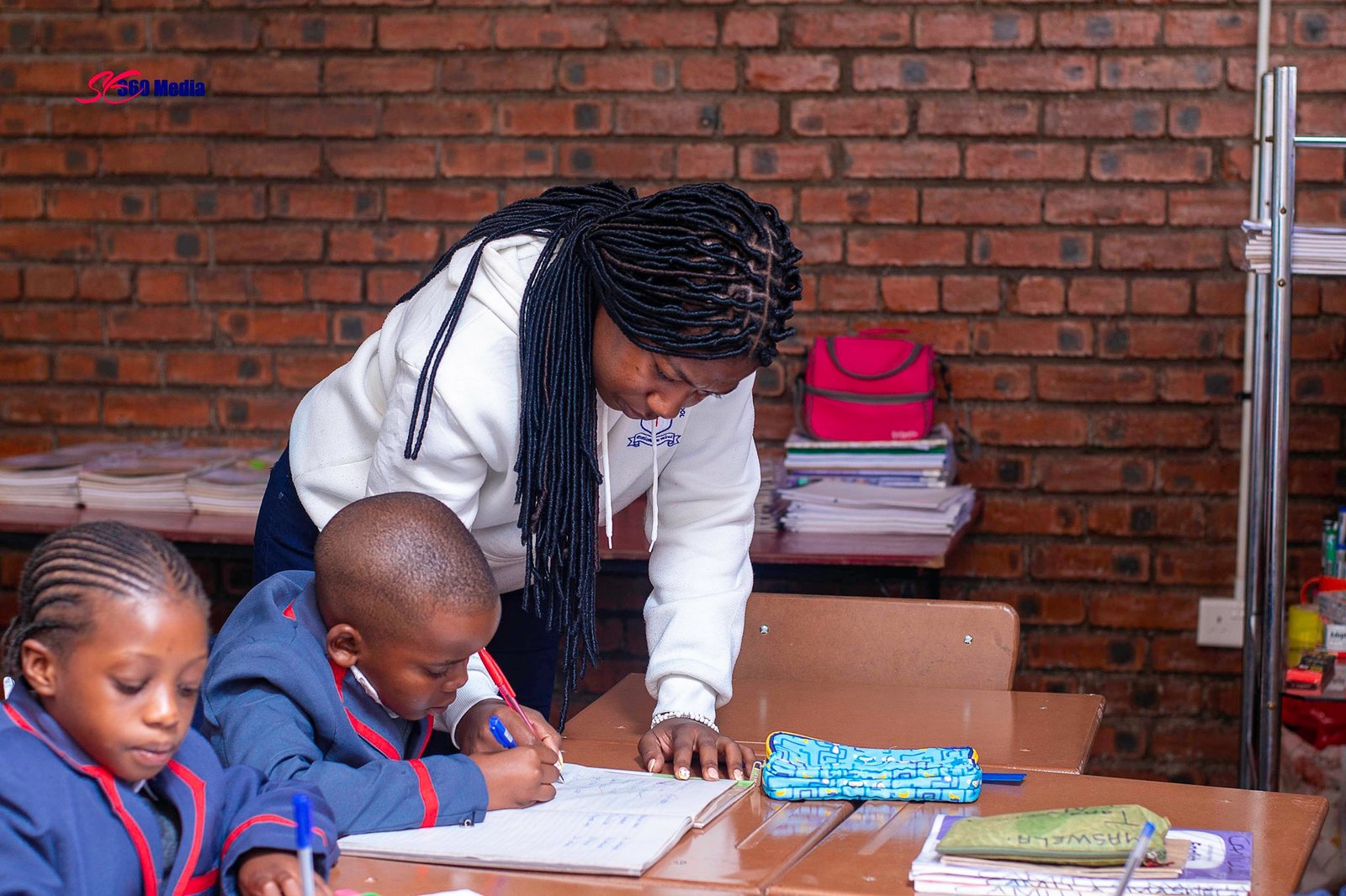 Teacher supporting a pupil during class